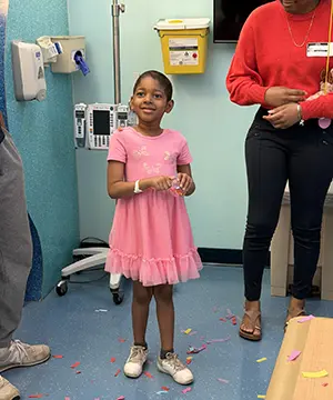 Amari happy in a pink dress